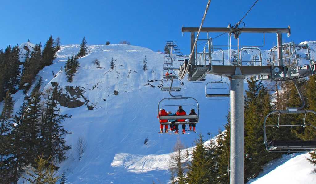 Ski lift with riders going up mountain. Best Colorado Winter Resorts
