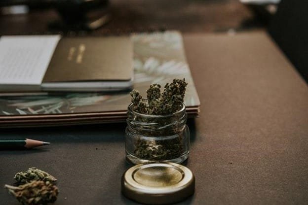 cannabis in a jar on a desk